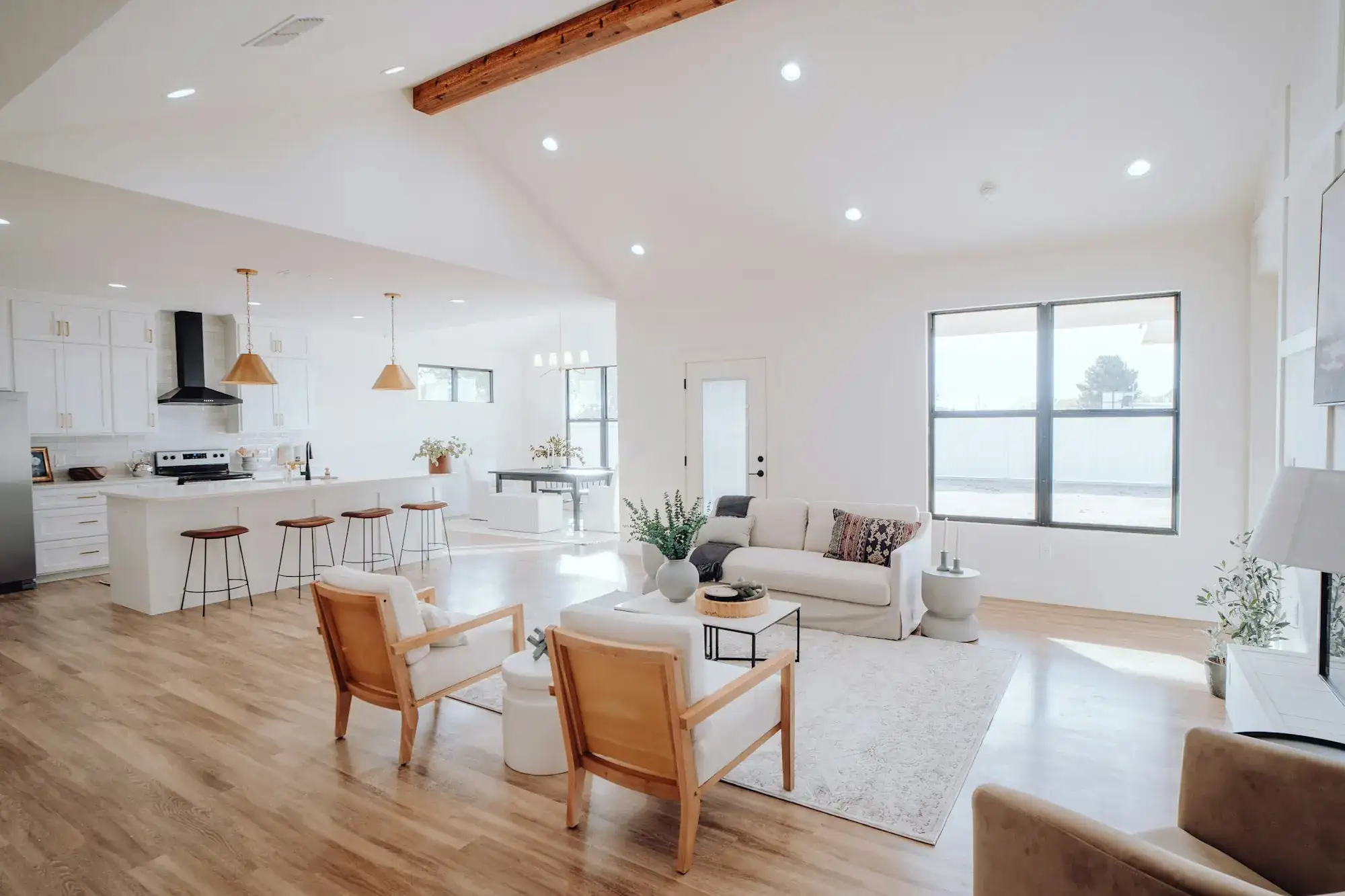 A finished open living room and kitchen with wood floors (stock photo)