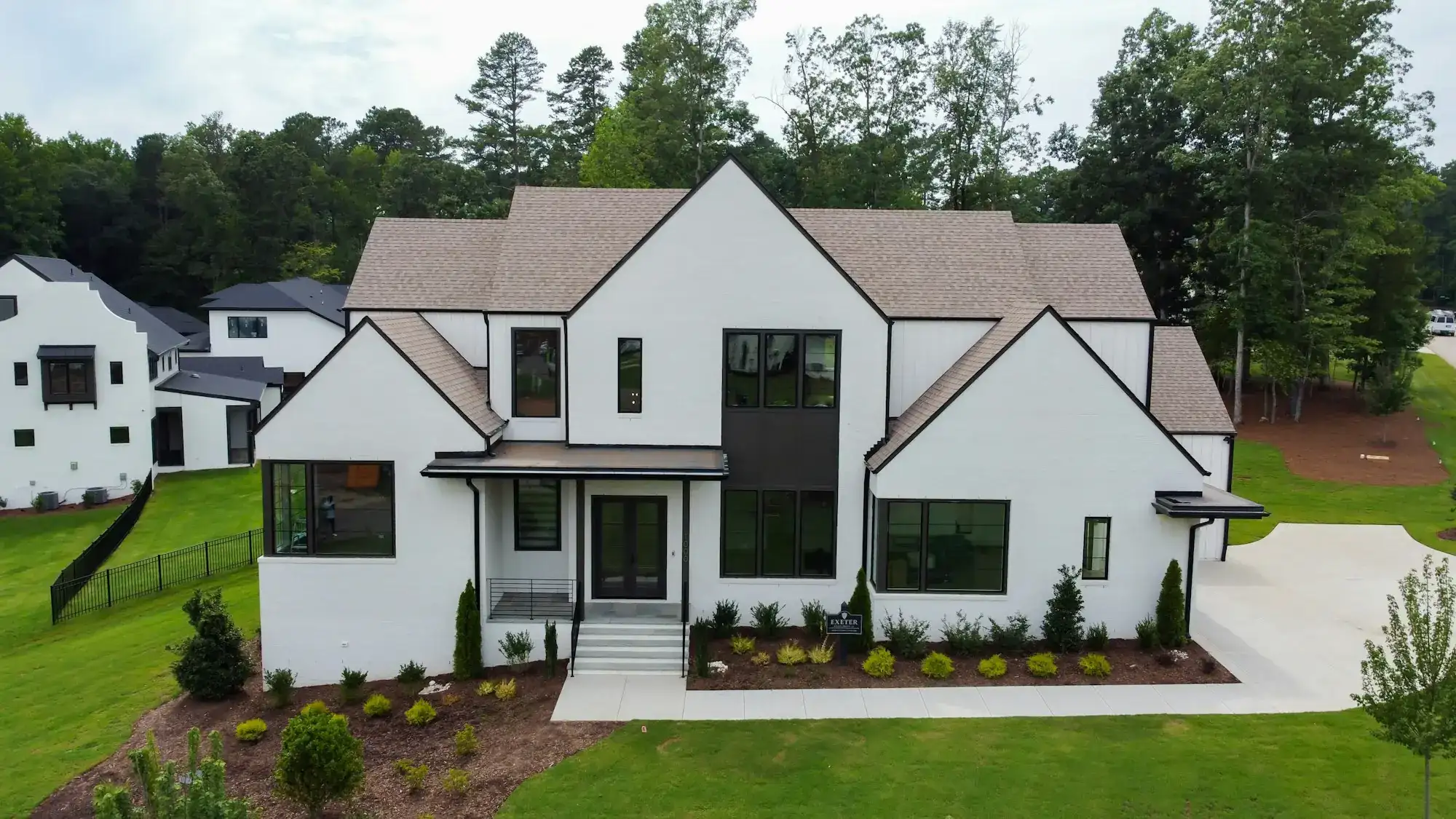 A modern white house with a green lawn (stock photo)