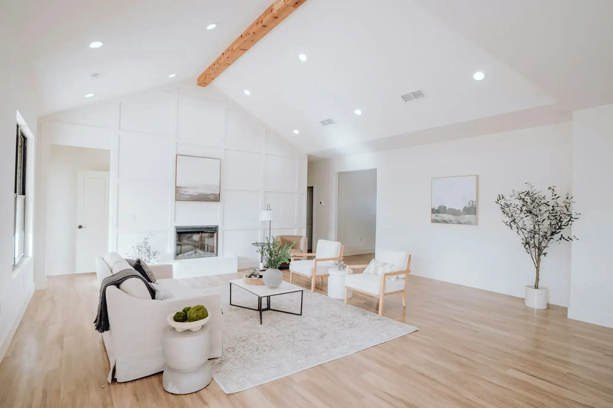 A finished living room with white furniture and wood floors (stock photo)